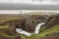 Icelandic landscape with Fljotsdalsvegur road, bridge, rock formations and Lagarfljot lake near the Litlanesfoss waterfall