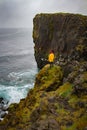 Icelandic landscape, person in yellow rain jacket. Amasing rock, Iceland.