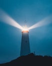 An Icelandic lighthouse in the moody dark night. Abstract image, dark mood. Iceland