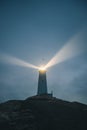 An Icelandic lighthouse in the moody dark night. Abstract image, dark mood. Iceland