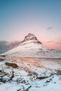 Icelandic Mount Kirkjufell before sunrise. Symmetrical mountain covered with snow on Snaefellsnes peninsula. Winter Nordic