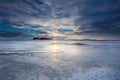 An Icelandic plane of ice covered by a dramatic sundown with reflections. Royalty Free Stock Photo