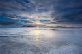 An Icelandic plane of ice covered by a dramatic sundown with reflections.