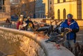 Icelandic retiree feeding ducks and swans bread from the snowy wall of Reykjavik\'s Tjornin lake with Royalty Free Stock Photo