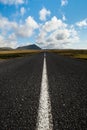 Icelandic road extending to the horizon under a summer sky