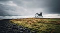 Icelandic style church sits in fenced field, in windswept landscape