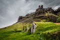 Icelandic turf houses covered with grass and cliffs in the background near Kalfafell vilage, South Iceland Royalty Free Stock Photo