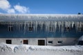 Icicle at roof of house in winter with blue sky Royalty Free Stock Photo