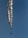 Icicle and water drop against the sky Royalty Free Stock Photo