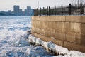 Icicles and blocks of ice on the concrete wall of the city embankment of the Amur River. border between states. Heihe