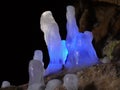 Icicles in a cave illuminated in color