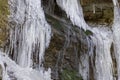 Icicles close-up with waterfall on the rocks