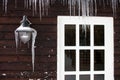 Icicles on the exterior of a panelled wooden house