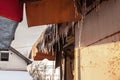 Icicles forming ice stalactites falling fron the edge of the eaves of gutters and roofs of a residential building during a cold Royalty Free Stock Photo