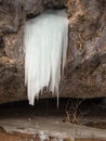 Icicles are growing from a hole in the rock