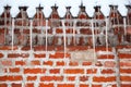 Icicles hang from the roof against a brick wall Royalty Free Stock Photo