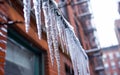 Icicles hanging from city structures - the beauty and danger of long icicles in a city Royalty Free Stock Photo