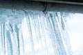Icicles hanging down from the gutter Royalty Free Stock Photo