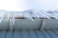 Icicles hanging down from the gutter Royalty Free Stock Photo