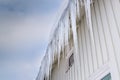 Icicles hanging down from the gutter Royalty Free Stock Photo