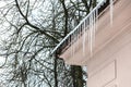 Icicles hanging down from the house eaves Royalty Free Stock Photo