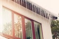 Icicles hanging on house roof