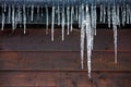 Icicles hanging outside a wooden panelled house
