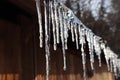 Icicles hanging from the roof. Frozen water. Royalty Free Stock Photo