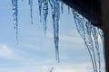 Icicles hanging from roof of house. Winter concept. Closeup danger icicles. Frozen climate pattern. Frost winter