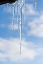 Icicles hanging from roof of house. Winter concept. Closeup danger icicles. Frozen climate pattern. Frost winter