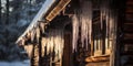 Icicles hanging from the roof of an old log hut -, concept of Winter wonderland