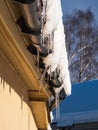 Icicles hanging from rooftop covered with a lot of snow Royalty Free Stock Photo