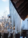 Icicles hanging from rooftop covered with a lot of snow Royalty Free Stock Photo