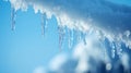 Icicles Hanging From a Snow Covered Surface Against a Blue Sky Royalty Free Stock Photo