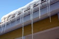 Icicles on house eaves Royalty Free Stock Photo