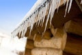 Icicles on an old log-house Royalty Free Stock Photo