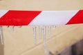 Icicles on red and white ribbon closeup Royalty Free Stock Photo