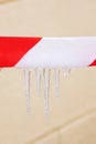 Icicles on red and white ribbon closeup Royalty Free Stock Photo