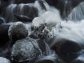 Icicles on rock in streaming water Royalty Free Stock Photo