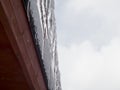 Icicles on the roof of the cottage Royalty Free Stock Photo