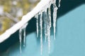 Icicles from the roof, frozen water hanging from the roof Royalty Free Stock Photo