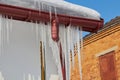 Icicles on the downpipe,icicles on the roof of the house on plastic drainage pipes, drainage pipes in winter Royalty Free Stock Photo