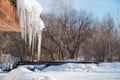 Icicles on the roof. Melt the snow on the roof of the house. Caution icicles. Ice hanging from the roof of the house Royalty Free Stock Photo