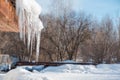 Icicles on the roof. Melt the snow on the roof of the house. Caution icicles. Ice hanging from the roof of the house Royalty Free Stock Photo