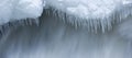 Icicles and snow near flowing water Royalty Free Stock Photo