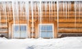 Icicles and snow on an old wooden cottage Royalty Free Stock Photo