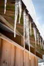 Icicles and snow on an old wooden cottage Royalty Free Stock Photo