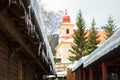 Icicles and snow on an old wooden cottage Royalty Free Stock Photo