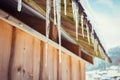 Icicles and snow on an old wooden cottage Royalty Free Stock Photo