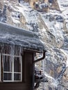 Icicles and snow on an old wooden cottage, Switzerland Royalty Free Stock Photo